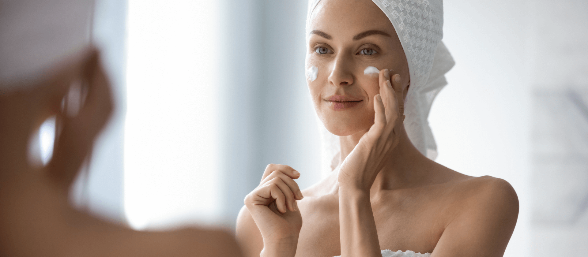 a woman looking in the mirror