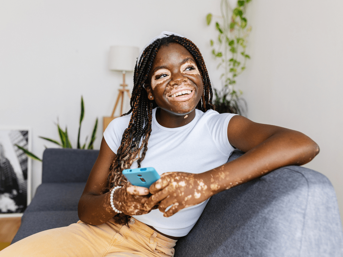 a girl smiling on the couch